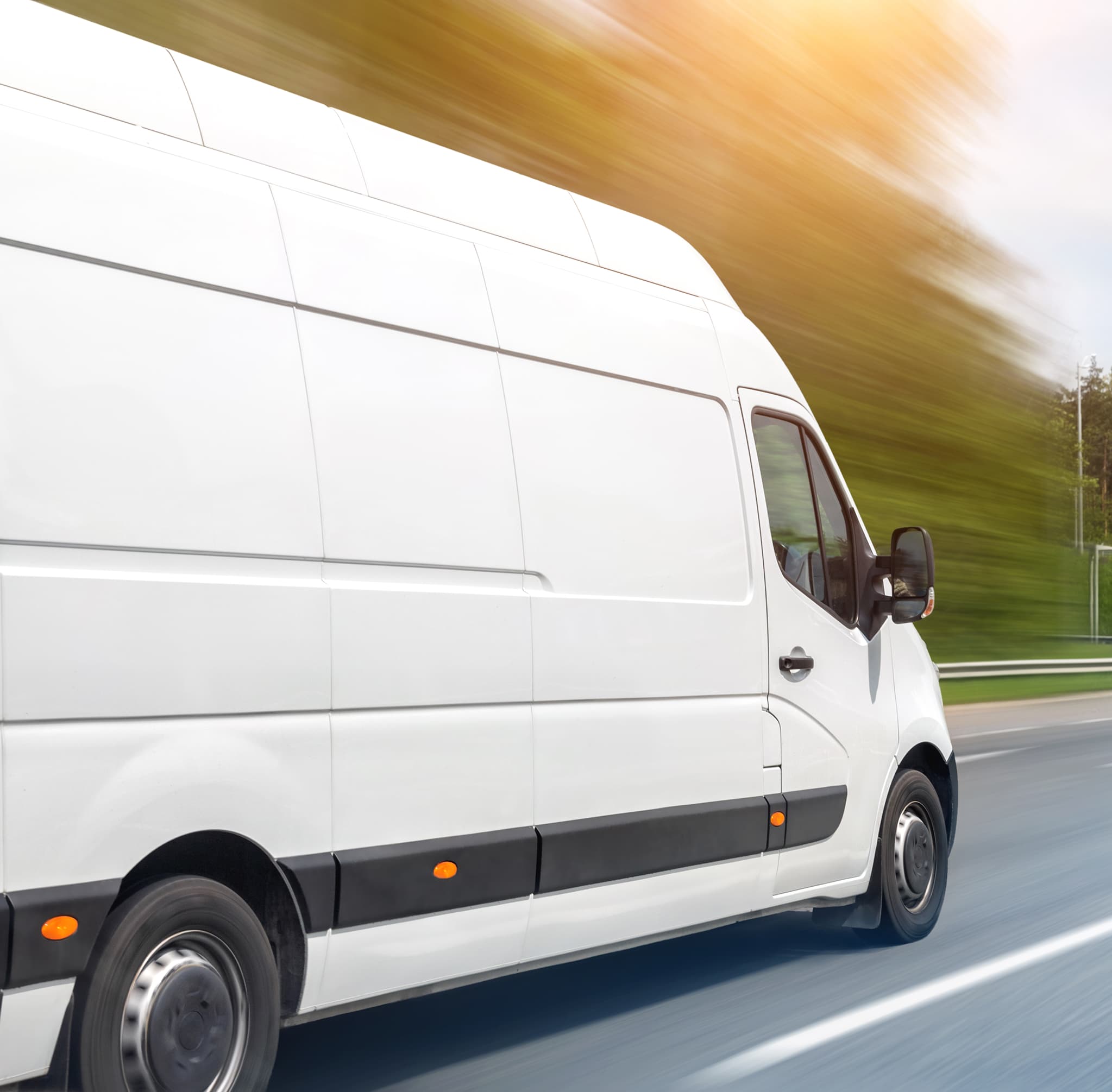 White delivery van driving on a road, motion blur